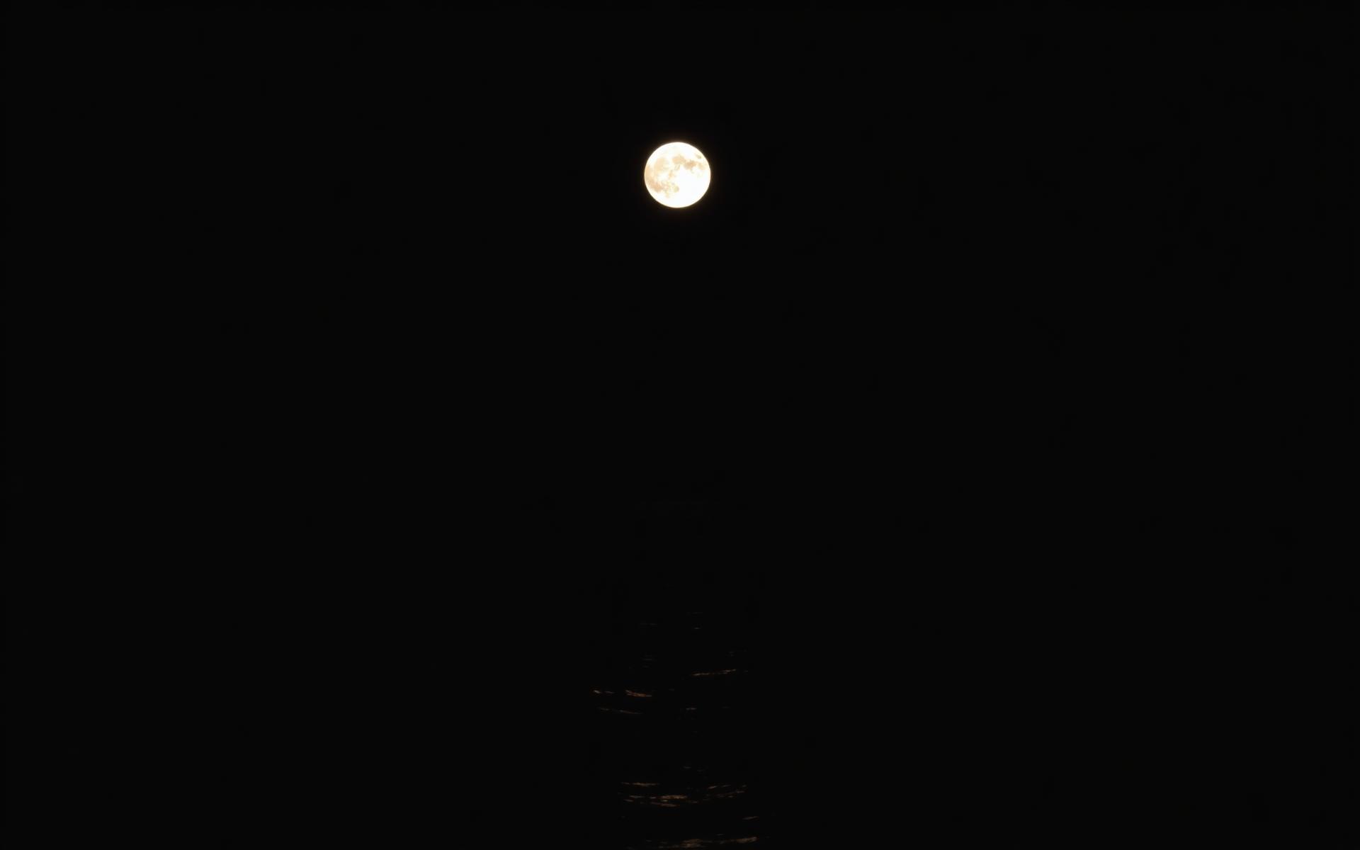 Full moon over the sea at night